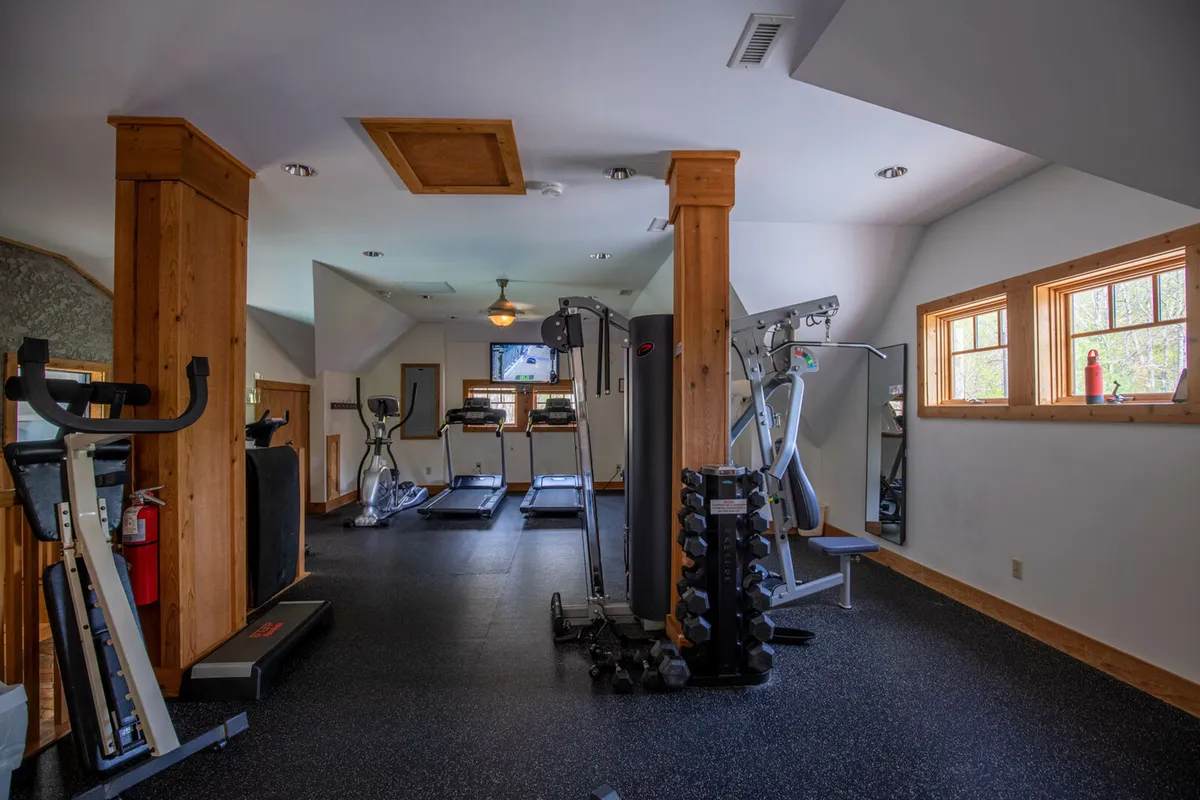 A bright, well-equipped fitness center with treadmills, weight machines, and a dumbbell rack, designed for individual or group workouts. The space is motivational, modern, and welcoming—perfect for staying active during your stay.